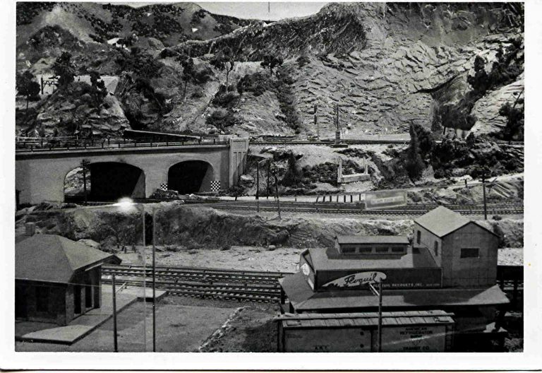 Black and white photo of a historic model railroad layout with bridges