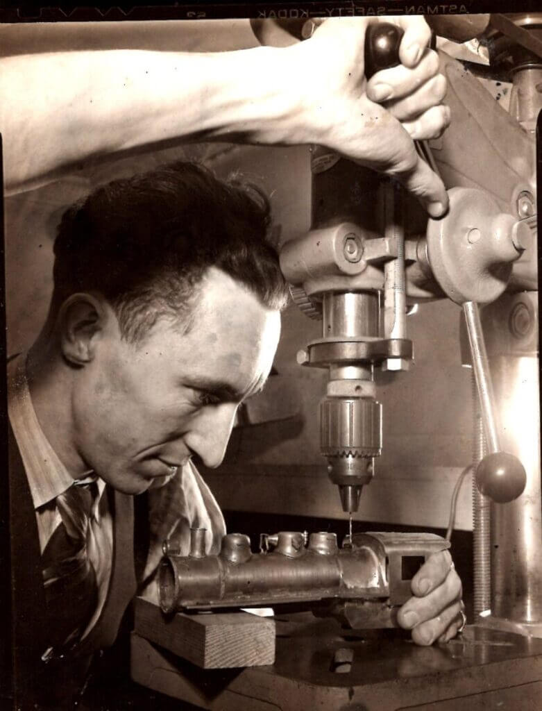 Machinist at a drill press, historic photo