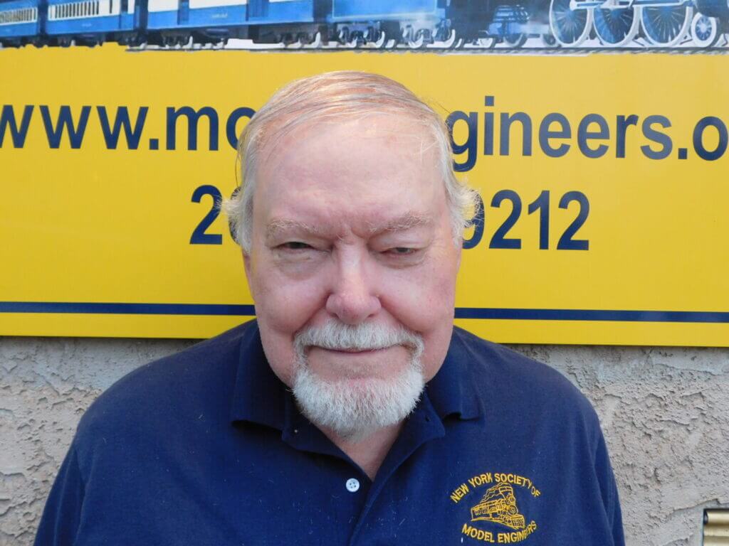 Club member with white beard in a navy shirt