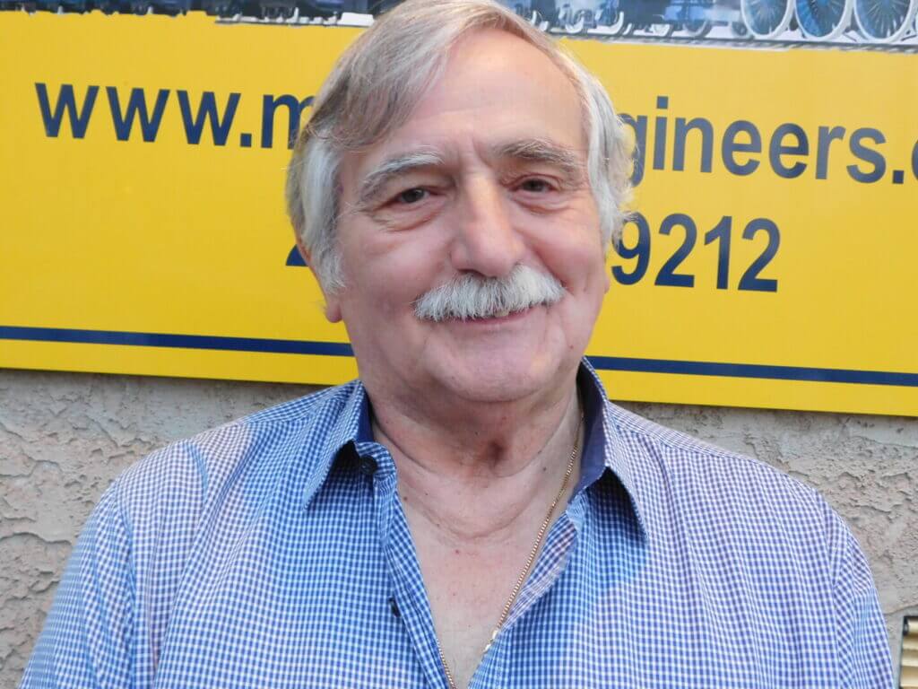 Club member with a mustache in a blue shirt